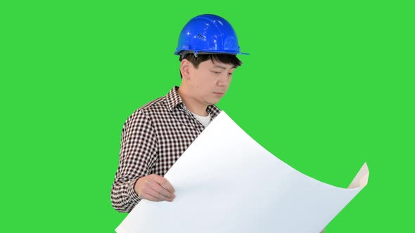 Engineer Walking and Looking at Blueprint on a Green Screen Chroma Key