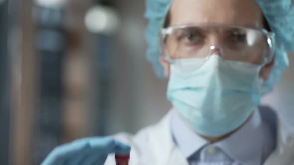 Special Laboratory Employee Showing Experimental Ebola Virus Vaccine, Healthcare
