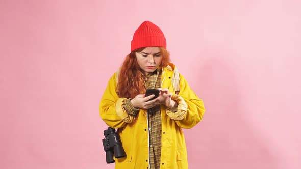 Charming Red-haired Girl Tourist Looking in the Mobile Navigator the Way To the Destination.