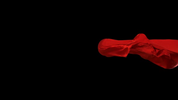 Red fabric flowing on black background, Slow Motion