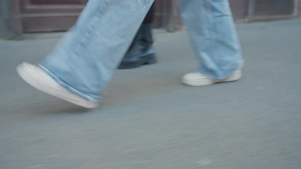 Mother And Daughter Walking Along Pavement In Prague