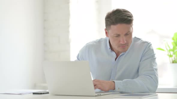 Man Feeling Distracted While working Laptop