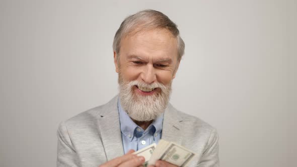Happy Old Man Counting Money Indoors