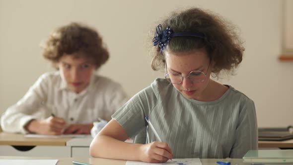 Back To School, Boy and Girl at Their Desks. Classmates in Class Laugh and Have Fun Together. Boy