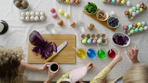 Top view of family prepare natural dyes for coloring eggs. Shot with RED helium camera in 8K.