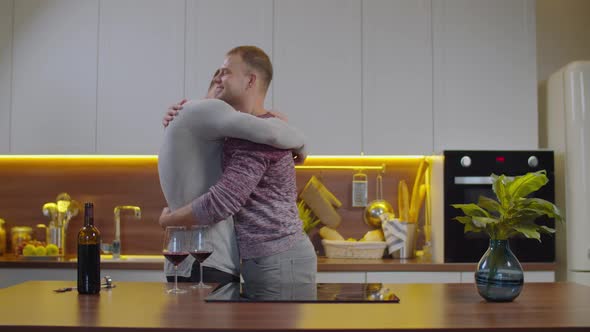 Smiling Affectionate Gay Couple Hugging Home