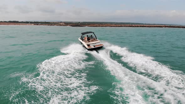 Speed Boat Sailing In The Calm Sea Making Foamy Waves Holidaymakers Having Fun