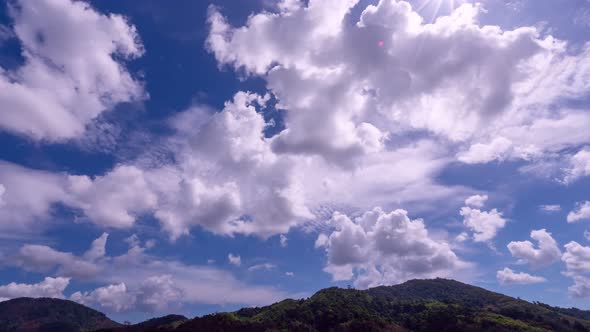 Blue sky white clouds with sun light flare Cumulus cloud cloudscape timelapse