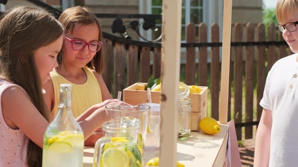 Girls Selling Lemonade To Boy