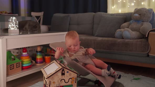 Baby Boy Playing with Wooden Busy House Montessori Educational Toy at Home