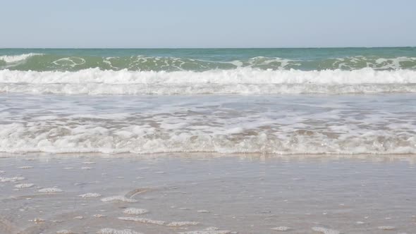 Dream ocean   waves  spreading on sandy beach in slow motion 1080p FullHD footage - Slow-mo scene of