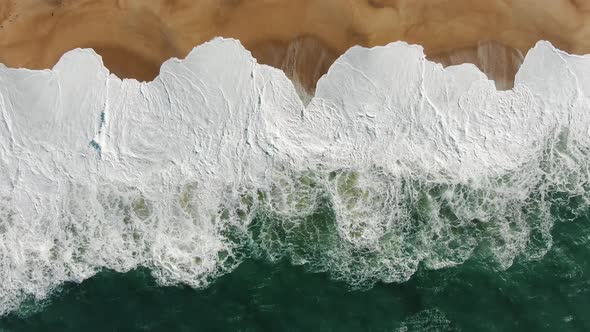 Panoramic View of Rolling Ocean Surf Covering Sand Beach