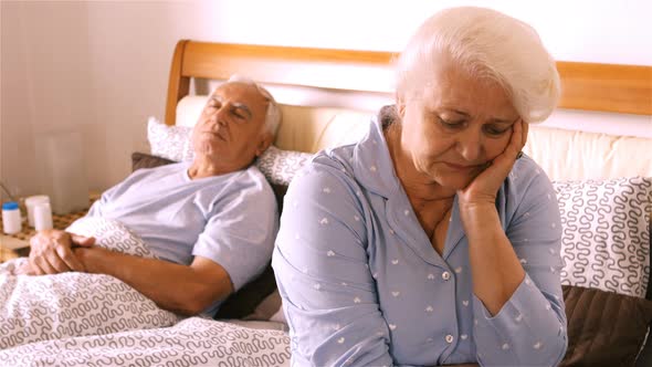 Worried senior woman sitting on bed / Videohive, Stock footage, People