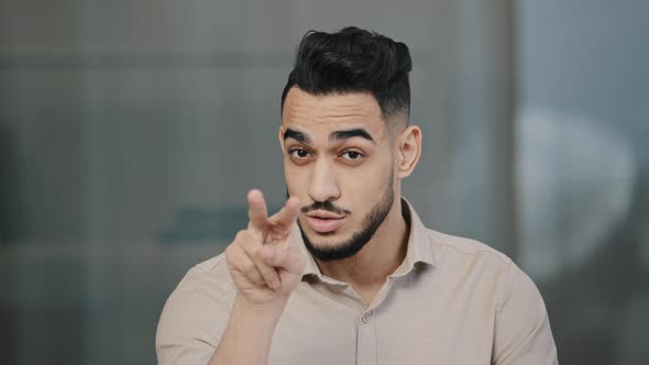 Serious Man Arabian Worker Entrepreneur Upset Nodds Head Pointing Fingers on Both Eyes Showing