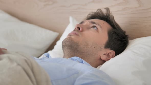 Uncomfortable Man Waking up from Sleep in Bed