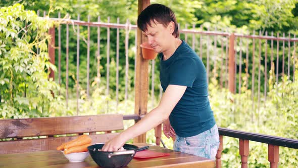 Guy Is Cooking Pilaf. Is in the Summer House, Preparing for a Picnic. Shows His Work