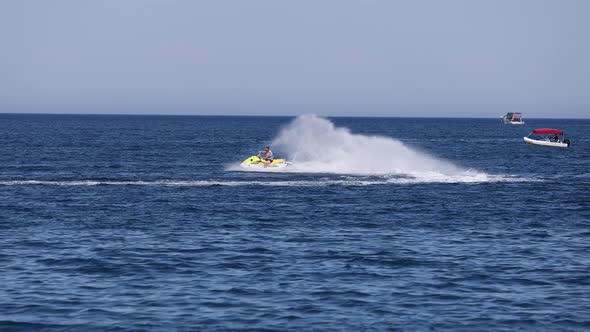 a Man Rides on the Sea Waves of the Mediterranean Sea on a Jet Ski