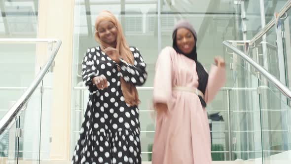 Two Muslim Joyful Business Woman Dancing for Joy at Work