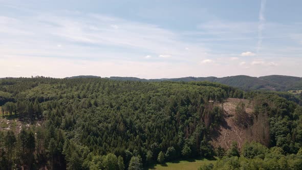 Vast mixed forests covering the hills of the Rhine-Sieg regional district on a sunny day. Wide angle