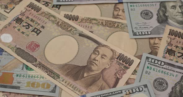 Stack of American USD and Japanese Yen banknote