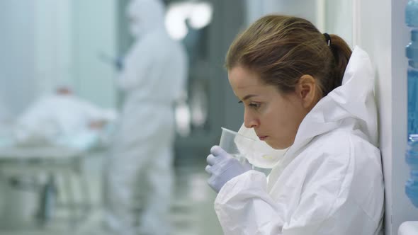 Portrait of Tired Female Doctor in Protective Suit at Work