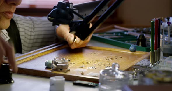 Close-up of horologist repairing a watch