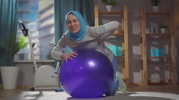 Portrait Muslim Woman on a Fitness Ball Injury and Back Pain