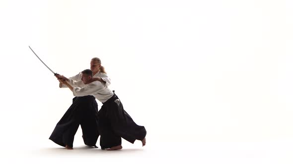 Athletes Demonstrating Aikido Using Katana. Isolated on White. Close Up