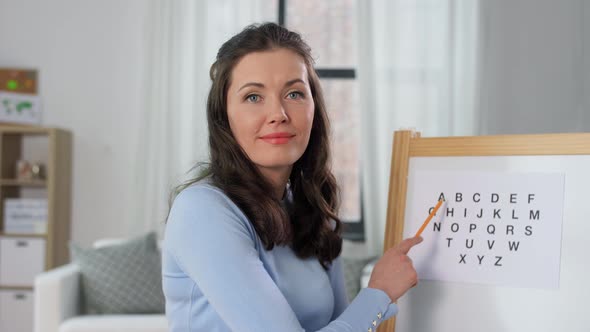 Teacher with Alphabet Having Online Class at Home