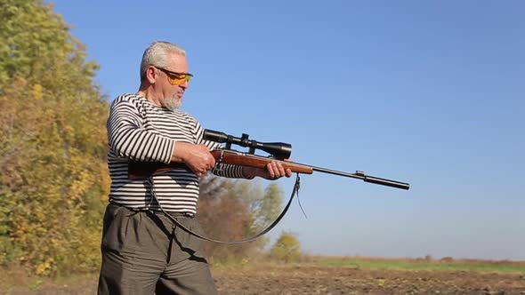 Hunter Aiming for a Rifle a Sniper