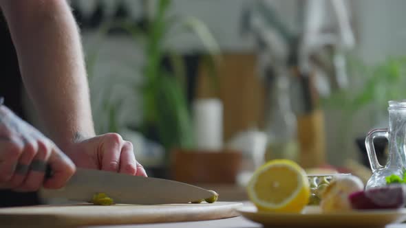 Chef Cutting Green Olives