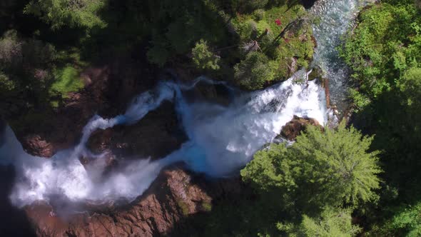 AERIAL PLAN VIEW, clean turquoise water in a stream to a waterfall, Iffigfall, Switzerland