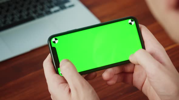 Man Using Smartphone with Chroma Key Closeup