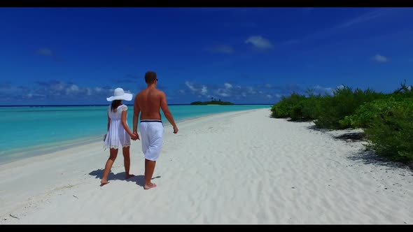 Romantic couple sunbathing on paradise island beach journey by blue sea with white sand background o