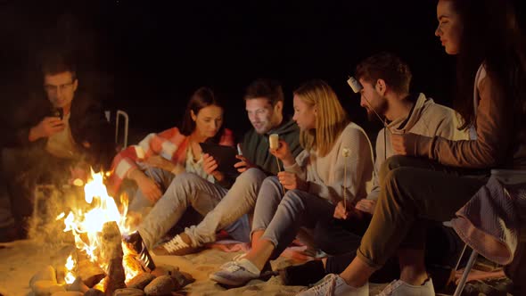 Friends with Marshmallow and Tablet Pc at Fire
