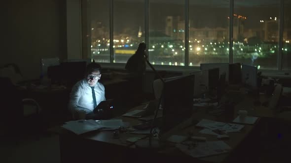Man Working at Dark Office