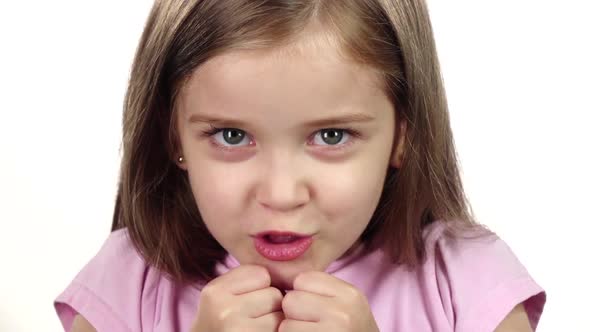 Child Is Angry, She Is Very Nervous. . White Background. Close Up. Slow Motion