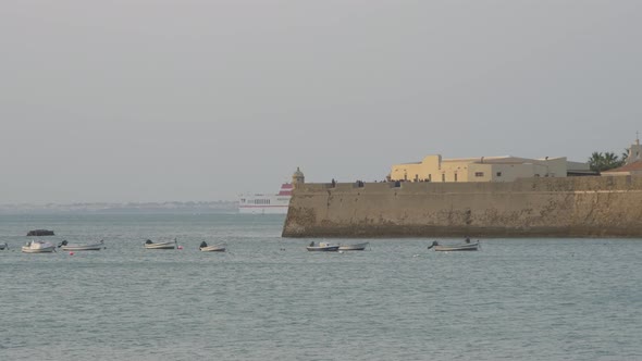 Anchored boats near a wall