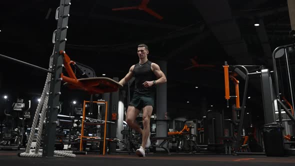 Muscular Sportsman Jump in Fitness Gym