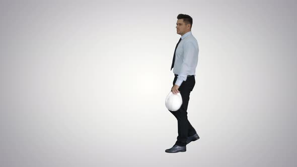 Businessman Putting Hardhat Helmet on Safety on Gradient Background.