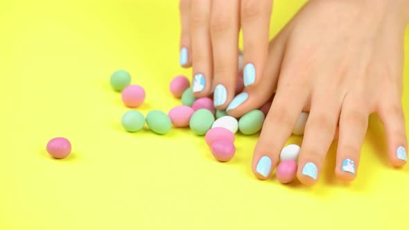 Manicured Hands and Multicolored Caramel Candies.