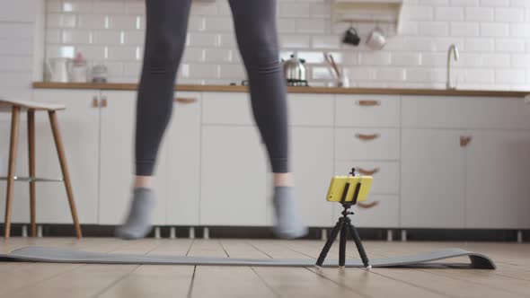 Young Woman Starts her Online Fitness Training