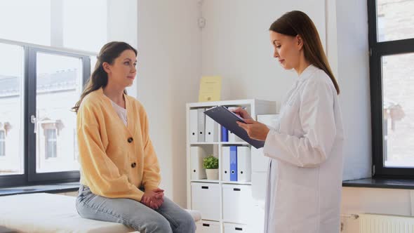 Doctor with Clipboard and Woman at Hospital