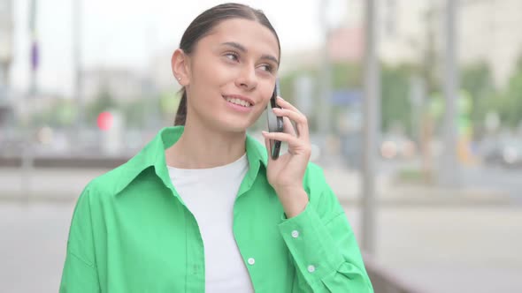 Hispanic Woman Talking on Phone While Standing Outdoor