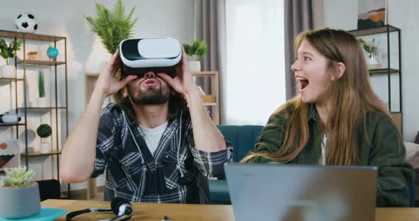 Smart Couple which Enjoying Virtual Reality Entertainment in Special 3d Glasses at Home