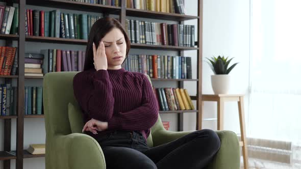 Headache Woman Sittinig on Sofa in Office Pain