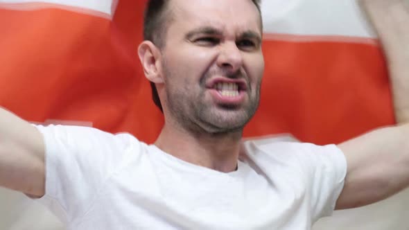 English Fan Celebrating While Holding the Flag of England