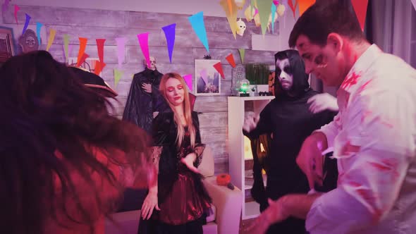 Group of Friends Dressed Up in Costumes for Halloween Party