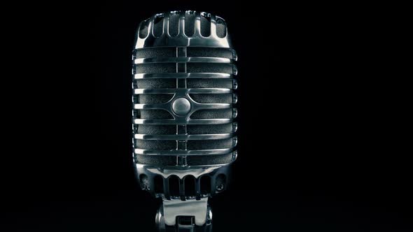 Microphone Comes Into View On Dark Background