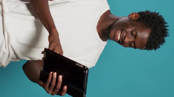 African American Man Using Digital Tablet and Smiling